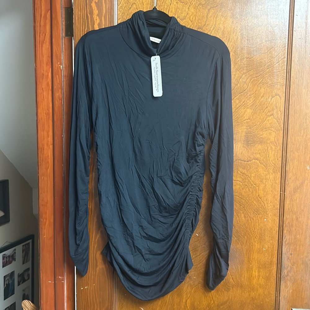 Soft surrounding turtleneck.  NWT medium